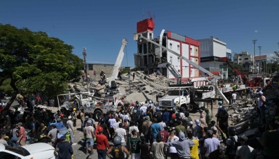 People look for survivors amid the rubble of a collapsed building after an earthquake in Cali, Colombia on August 10, 2026. (Photo by JOAQUIN SARMIENTO / AFP)
