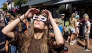 A woman wears eclipse glasses in Almelo, eastern Netherlands on August 11, 2026 on the eve of a partial solar eclipse. Photo by Vincent Jannink / ANP / AFP