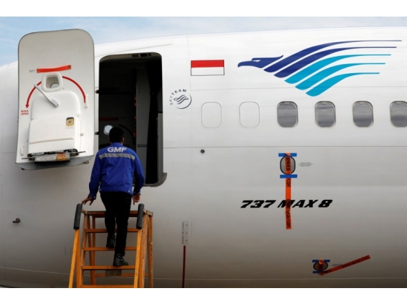 Reuters file photo for representation showing a technician boarding a parked Garuda Indonesia airplane.