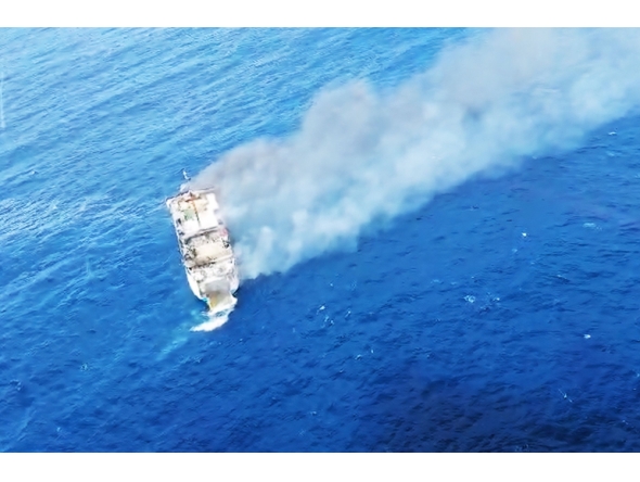 This screen grab picture from a handout video taken and released on August 12, 2026 by the Indonesian National Search and Rescue Agency (Basarnas) shows the Putri Yasmin ferry, which serves the Padangbai-Bali- to Lembar-West Nusa Tenggara route, on fire in the waters of Bali. (Photo by Handout (Green Road Waste Management ) / Indonesian National Search and Rescue Agency (BASARNAS) / AFP)