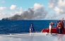 This screen grab picture from a handout video taken and released on August 12, 2026 by the Indonesian National Search and Rescue Agency (Basarnas) shows the Putri Yasmin ferry, which serves the Padangbai-Bali- to Lembar-West Nusa Tenggara route, on fire in the waters of Bali. (Photo by Handout (Green Road Waste Management )