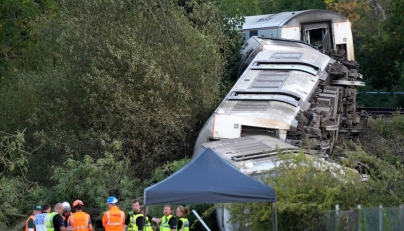 Carriages of a derailed train are pictured on their side, near the town of Lewes, southern England on August 13, 2026. Two people sustained 