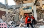 This handout picture taken and released on August 15, 2026 by Indonesia's National Search and Rescue Agency (BASARNAS) shows rescuers working amid the rubble of a damaged building after an earthquake in Maumere, East Nusa Tenggara (Photo by Handout / Indonesia's National Search and Rescue Agency (BASARNAS) / AFP)