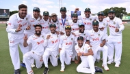 Bangladesh players pose for a photo after their team's victory on the fourth day of the first cricket Test match between Australia and Bangladesh at Marrara Stadium in Darwin on August 16, 2026. (Photo by William WEST / AFP)