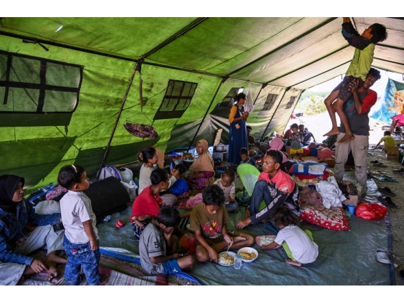 Villagers rest in a tent on an open field in Marapokot, Nagekeo, East Nusa Tenggara, on August 17, 2026, following a 7.7-magnitude earthquake. T (Photo by JUNI KRISWANTO / AFP)