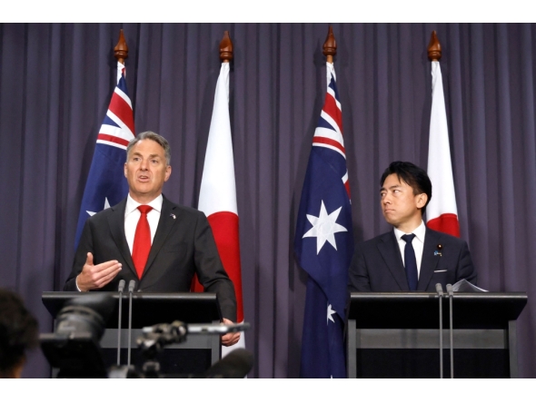 Japan's Defence Minister Shinjiro Koizumi (R) stands with Australian Deputy Prime Minister and Defence Minister Richard Marles (L) during a press conference at Parliament House in Canberra on August 18, 2026. (Photo by HILARY WARDAUGH / AFP)