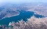 This aerial photo taken on August 6, 2026, shows low water levels in Lake Mead in Nevada. In mid-July, the combined water levels of Lake Powell and Lake Mead, the two largest reservoirs in the United States and both fed by the Colorado River, reached their lowest levels in over 60 years. The Colorado River provides drinking water for more than 40 million people and fuels hydropower across seven states. (Photo by Eva Claire HAMBACH / AFP)