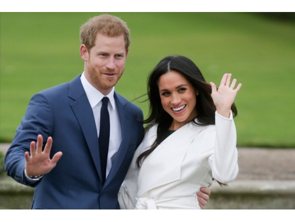 (FILES) Britain's Prince Harry and Meghan Markle pose for a photograph in the Sunken Garden at Kensington Palace in west London on November 27, 2017, following the announcement of their engagement. (Photo by Daniel LEAL / AFP)