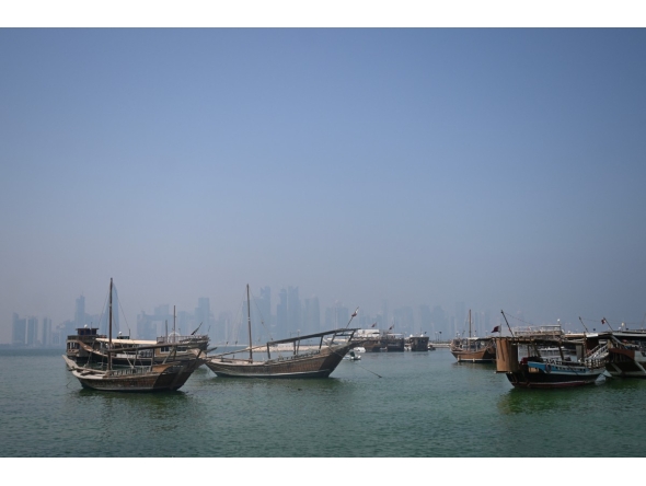 Traditional wooden boats are anchored in front of the Doha skyline on August 19, 2026. (Photo by Mahmud Hams/ AFP)

