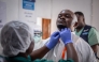 A medical worker puts on a protective suit at an Ebola treatment center in Beni, North Kivu Province, the Democratic Republic of the Congo, Aug. 16, 2026. (Xinhua)