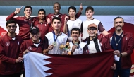 Qatar's players and officials pose for a group photo. 