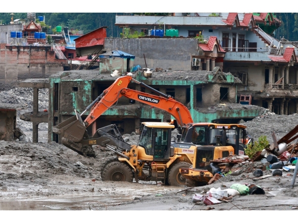 Workers use excavators to clear the mud at the Dhunge Bazaar in Nepal's Nuwakot district on August 29, 2026 after flash floods and landslides hit the Nepal-Tibet border. (Photo by PRABIN RANABHAT / AFP)