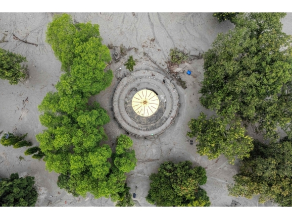 This aerial photograph shows the Neelkantha Hindu temple covered heavily under sludge in the aftermath of flash floods at Devighat in Nepal's Nuwakot district on August 29, 2026. (Photo by Manan VATSYAYANA / AFP)