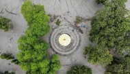 This aerial photograph shows the Neelkantha Hindu temple covered heavily under sludge in the aftermath of flash floods at Devighat in Nepal's Nuwakot district on August 29, 2026. (Photo by Manan VATSYAYANA / AFP)