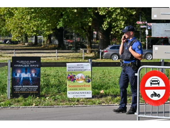 Police officers secure the area next to a poster advertising a rave where a shooting occurred, in Aarau, northern Switzerland, on August 30, 2026. Photo by Harold CUNNINGHAM / AFP