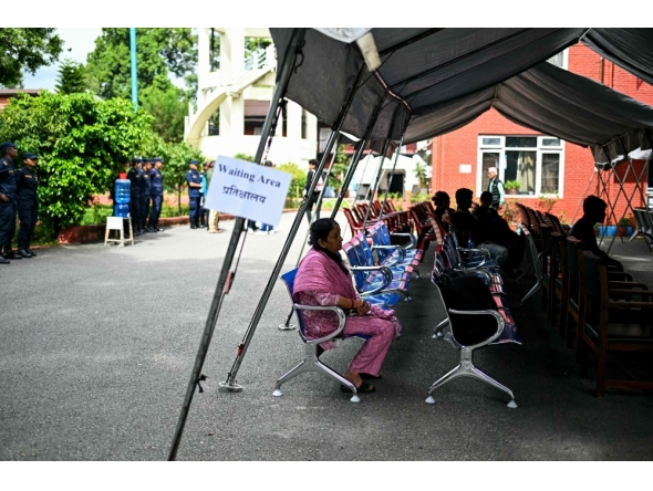 Family members wait to register their information with police personnel to give blood samples for DNA testing to help identify their missing relatives after flash floods, at the Nepal Police Hospital in Kathmandu on September 3, 2026.  (Photo by Manan VATSYAYANA / AFP)
 
