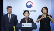 Republic of Korea Prime Minister Han Seong-sook (C) speaks as Interior and Safety Minister Yun Ho-jung (L) looks on during a press conference announcing the relocation plan of government agencies at the government complex in Seoul on September 3, 2026. (Photo by YONHAP / AFP) 