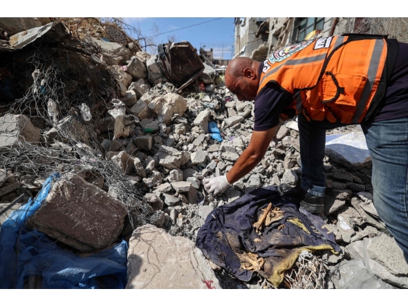 A Civil Defence member collects human remains in the rubble of Al-Muhandisin Tower, that was destroyed in Israeli strikes in the Nuseirat camp for refugees in the central Gaza Strip on September 5, 2026. (Photo by Eyad BABA / AFP)