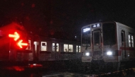 Trains cross during a heavy rainstorm in Tokyo on September 6, 2026 after Japan's weather agency warned of intense rain around the region. (Photo by Andrew CABALLERO-REYNOLDS / AFP)