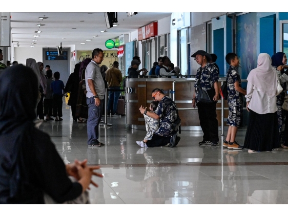 Passengers wait at a terminal of Iskandar Muda airport in Blang Bintang on September 6, 2026. Indonesia halted operations at its main international airport outside Jakarta on September 6, after ash spewed from the Anak Krakatoa volcano more than 150 kilometres away, impacting thousands of passengers. (Photo by CHAIDEER MAHYUDDIN / AFP)
