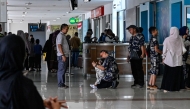 Passengers wait at a terminal of Iskandar Muda airport in Blang Bintang on September 6, 2026. Indonesia halted operations at its main international airport outside Jakarta on September 6, after ash spewed from the Anak Krakatoa volcano more than 150 kilometres away, impacting thousands of passengers. (Photo by CHAIDEER MAHYUDDIN / AFP)
