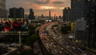 Commuters drive past commercial and residential buildings during the early evening rush hour traffic in Bangkok on September 4, 2026. (Photo by Anthony WALLACE / AFP)
