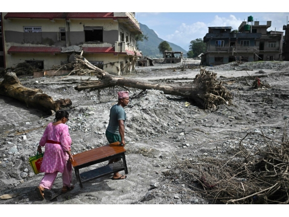People recover their belongings in the aftermath of flash floods at Devighat in Nepal's Nuwakot district on September 8, 2026. Photo by Pedro PARDO / AFP