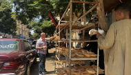 People queue outside a bakery to buy government-subsidised traditional pita bread in Cairo on August 17, 2026. Photo by Khaled Desouki / AFP

