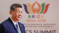 In this pool photograph distributed by the Russian state agency Sputnik, China's President Xi Jinping arrives before the start of the 18th BRICS Summit in New Delhi on September 12, 2026. (Photo by Alexander Kazakov / Pool / AFP)