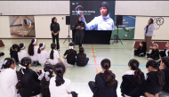Ibtihaj Muhammad speaking to the young athletes during the Qatar Foundation’s Touché: International Fencing Day event at Education City.