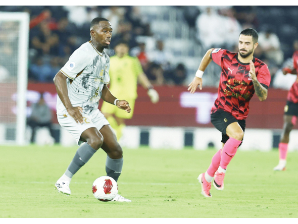 Al Duhail's Boubakary Soumare (left) controls the ball.