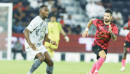 Al Duhail's Boubakary Soumare (left) controls the ball.