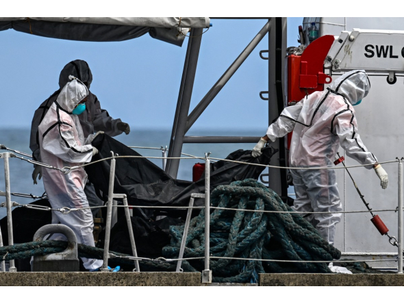 Philippine Coast Guard personnel in protective suits carry a body bag of a victim from the ferry fire to a tent for identification at the port of Borac in Coron, Palawan province on September 13, 2026. Photo by JAM STA ROSA / AFP