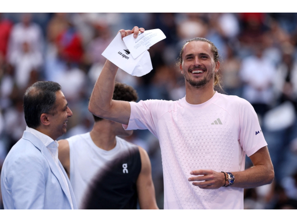 Alexander Zverev of Germany celebrates with the winner's check after defeating Ben Shelton of the United States in their Men's Singles Final match on Day Fifteen of the 2026 US Open at USTA Billie Jean King National Tennis Center on September 13, 2026 in the Flushing neighborhood of the Queens borough of New York City. (Photo by  Matthew Stockman/Getty Images/AFP) 