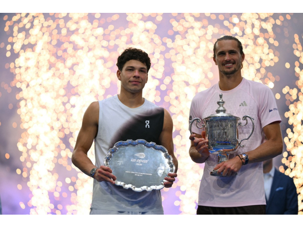 USA's Ben Shelton holds the runner-up trophy next to Germany's Alexander Zverev who holds the winner's trophy after the men's singles final tennis match of the US Open tennis tournament on September 13, 2026. (Photo by Angela Weiss / AFP)
