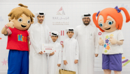 Officials with children during the event.