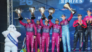 Team Qatar drivers celebrate on the podium. 