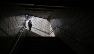 A person walks down the entrance of a metro station in Seoul on September 20, 2026. (Photo by Lillian SUWANRUMPHA / AFP)