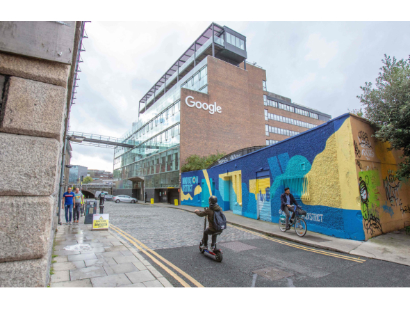  Members of the public pass the offices of Google in the business and financial sector of Dublin, Ireland on October 7, 2021. Photo by PAUL FAITH / AFP