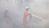Firefighters extinguish forest and land fires in Banjar, South Kalimantan, on September 21, 2026. (Photo by Muda Sagala / AFP)