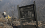 A sign for the Iguaque Fauna and Flora Sanctuary stands amid burned vegetation on San Marcos Hill following a forest fire in the municipality of Villa de Leyva, Boyaca department, Colombia, on September 20, 2026. (Photo by LUIS LIZARAZO / AFP)