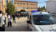 This handout photograph by Turkish news agency DHA (Demiroren News Agency) shows ambulances and police officers in front of the high school in Turgutlu. (Photo by Handout / DHA / AFP)