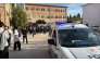 This handout photograph taken and released on September 22,2026 by Turkish news agency DHA (Demiroren News Agency) shows ambulances and police officers waiting in front of a high school outside which a gunman opened fire wounding eight people, and was detained shortly afterwards, in Turgutlu, an area west of the resort city of Izmir. (Photo by Handout / DHA (Demiroren News Agency) / AFP)