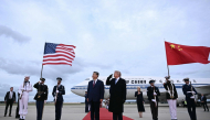 US President Donald Trump reacts after a B1 bomber flew past during the national anthems while he greeted Chinese President Xi Jinping upon his arrival at Joint Base Andrews in Maryland on September 23, 2026. (Photo by Brendan Smialowski / AFP)