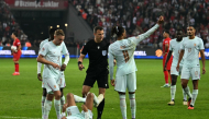 France's forward #10 Kylian Mbappe (C) reacts after scoring the opening goal and to a leg pain on September 25, 2026. (Photo by Ozan Kose / AFP)