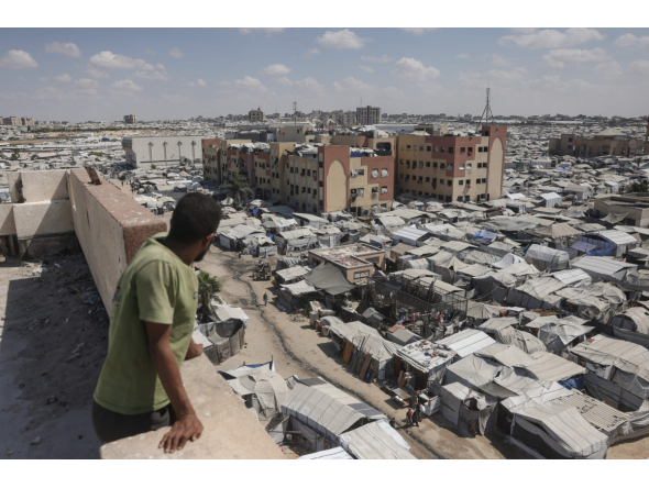 A man standing on top of a building looks at tents of displaced Palestinians in Al-Mawasi area of Khan Yunis in the southern Gaza Strip on September 25, 2026. (Photo by BASHAR TALEB / AFP)