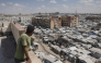 A man standing on top of a building looks at tents of displaced Palestinians in Al-Mawasi area of Khan Yunis in the southern Gaza Strip on September 25, 2026. (Photo by BASHAR TALEB / AFP)