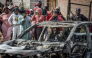 Residents stand behind police tape near the scene where gunmen armed with assault rifles stormed a bar in Johannesburg on September 27, 2026. Photo by EMMANUEL CROSET / AFP