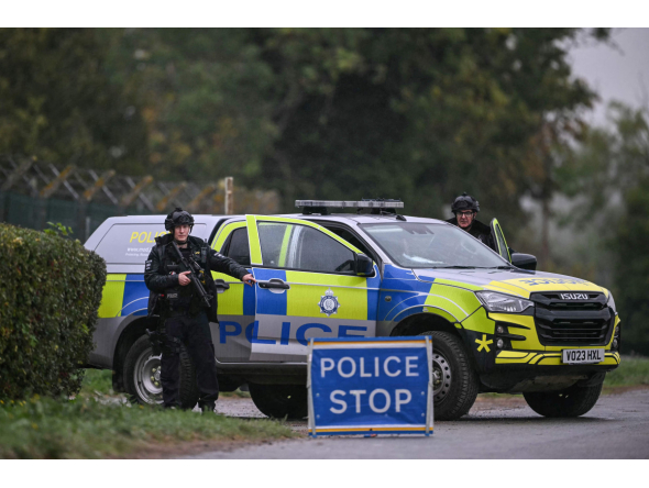 Armed police man a roadblock while posted outside RAF Fairford base in Fairford, south-west England on September 27, 2026, as UK counter-terrorism police investigate an incident near the base in the village of Whelford. Photo by JUSTIN TALLIS / AFP