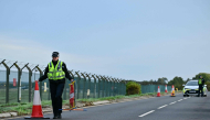 Police continue to man a roadblock outside RAF Fairford base (L) in Fairford, south-west England on September 28, 2026. (Photo by Ben Stansall / AFP)